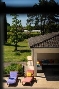 a group of chairs sitting next to a house at Les Martinets in Fongrave