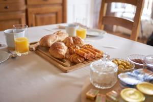 a table topped with a tray of pastries and orange juice at RENAISSANCE in Saint-Germain-du-Plain