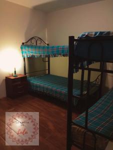 a room with two bunk beds and a sign that says hello at La casita de Lulú in Arequipa