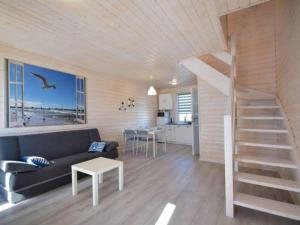 a living room with a staircase in a house at Ferienhaus für 5 Personen ca 55 qm in Mielno, Ostseeküste Polen in Mielno