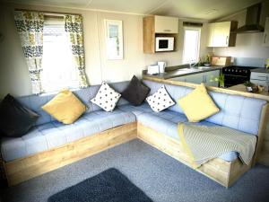 a blue couch with pillows on it in a kitchen at Tigh na Mara in Padstow
