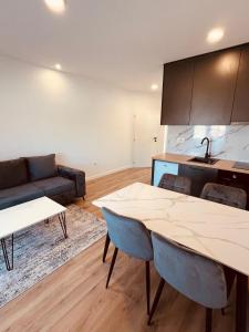 a living room with a table and a couch at Apartmani Covic Medjugorje in Međugorje