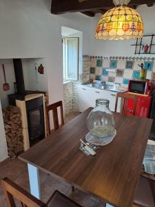a kitchen with a wooden table with a vase on it at la casina di asia in Semproniano