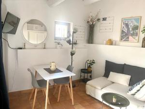 a living room with a couch and a table at La Maisonnette de Bédoin Mont Ventoux - Self Check In in Bédoin