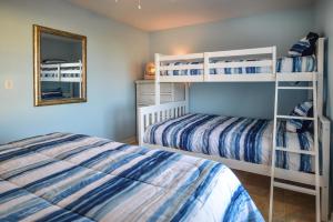 a bedroom with two bunk beds and a mirror at Super Cute With Deeded Beach Access (#26) - Sleeps 5 in Gulf Shores