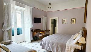 a bedroom with a bed and a desk and a window at Il Palazzo in Scanno