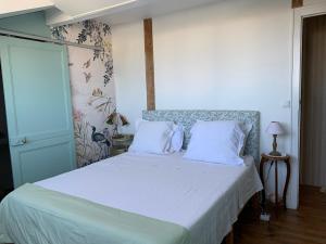 a bed with white sheets and pillows in a bedroom at La Croix Blanche in Dax +63 photos