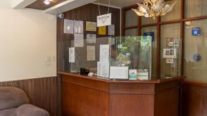 a display case in a room with a chandelier at El Prado Hotel in Cochabamba