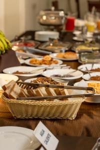 a long table with plates of food on it at El Prado Hotel in Cochabamba