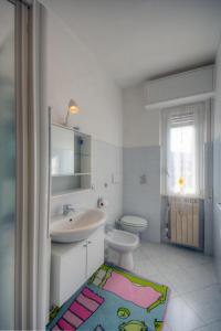 a bathroom with a sink and a toilet at A Gonfie Vele VADOALMARE Immobiliare in Vado Ligure +10 photos