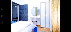 a bedroom with a white bed and a mirror at Airport apartment 2 