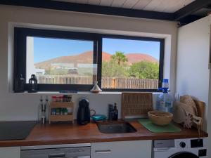 eine Küchentheke mit Spüle und Fenster in der Unterkunft Villa Calderón Hondo in Lajares + 10 Fotos