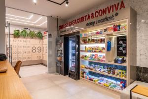 a grocery store with a refrigerator and shelves of food at Lobie Casa Mauá in Rio de Janeiro