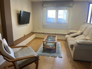 a living room with a couch and a coffee table at Brisa mariña in Isla de Arosa