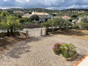a patio with flowers and plants in a yard at Villa 3 Quartos, BBQ, AC, Garagem, Prestige For Home in Romão