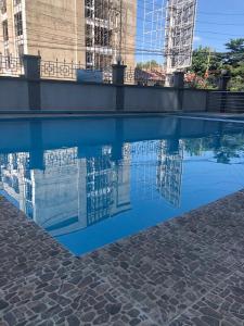 a reflection of a building in a pool of water at StarLuxe Condo in Nairobi