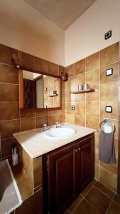 a bathroom with a sink and a mirror at Casa Christine in Playa Migjorn