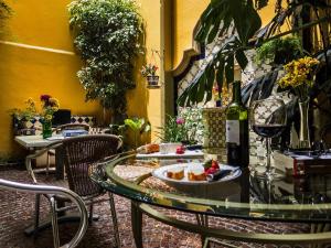 a glass table with a plate of food on it at Chalet del Carmen, Coyoacán in Mexico City