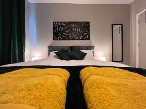 1 dormitorio con 1 cama grande con mantas amarillas en A Cosy Apartment Close to City Centre, en Norwich