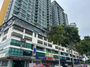 a tall building with cars parked in front of it at Noah's Studio in Shah Alam