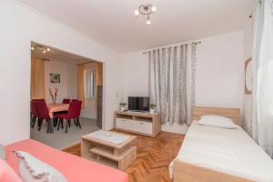 a bedroom with a bed and a dining room with a table at Apartment Island Sun Terrace in Krapanj