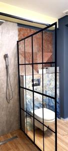 a shower stall with a toilet in a room at Mogosoaia High Living Mansion in Chitila