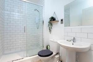 a bathroom with a toilet and a sink and a shower at Central Gloucester Getaway Retreat W/Free Parking 