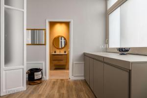 a bathroom with a sink and a mirror in a room at Constance Luxury Apartment by DomuSicily in Palermo