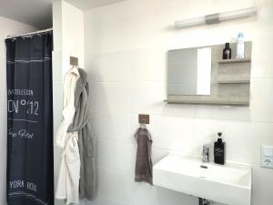 a bathroom with a sink and a mirror at Ferienhaus Richard in Eschwege