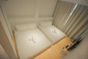an overhead view of two beds in a room at Double H Boutique Hotel in Kuala Terengganu