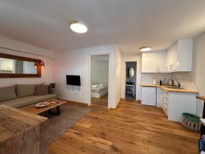 ein Wohnzimmer mit einem Sofa und einer Küche in der Unterkunft Merriam mykonos town in Mykonos Stadt