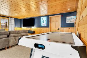 a pool table in a room with a couch and a tv at Chalet*Mountain Views*3-mins Sunday River*Hot Tub in Newry