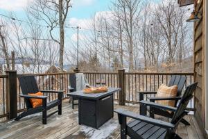 a patio with two chairs and a table on a deck at Chalet*Mountain Views*3-mins Sunday River*Hot Tub in Newry