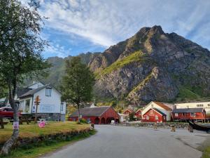 a small town in front of a mountain at Villa The high end of Lofoten in Moskenes