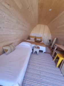 阿尔戈什Eco Cabin - Villa das Alfarrobas的小木屋内带两张床的房间