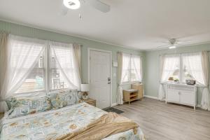 a bedroom with a bed and two windows at Beachfront Salisbury Retreat with Fire Pit and Grill in Salisbury