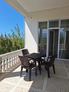 a black table and two chairs on a patio at Sweet Home Near Black Sea in K'obulet'i