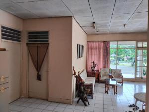 a living room with a table and chairs at Villa Ledenfi in Cisarua