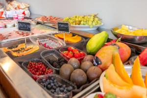 a display of fruits and vegetables on a buffet at Hotel Europa in Gabicce Mare