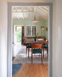 a dining room with a table and chairs at Casa da Encosta - Hillside cabin near the sea in Colares
