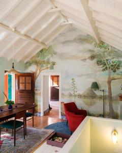 a living room with a painting on the wall at Casa da Encosta - Hillside cabin near the sea in Colares