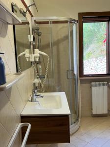 a bathroom with a shower and a sink at Villa Bella Vista in Capo Vaticano