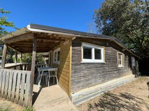 a small wooden shed with a table in it at Camping Le Repos in Saint-Palais-sur-Mer