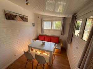 a room with a table and chairs in a tiny house at Camping Le Repos in Saint-Palais-sur-Mer +113 photos