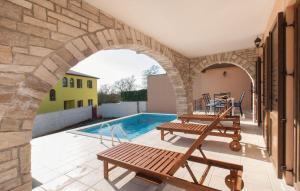 a patio with an archway and a swimming pool at Villa With Pool in Croatia Vrsar in Gradina