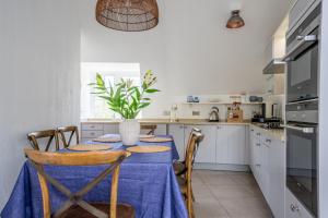 a kitchen with a table with a vase on it at York Cottage in Whitby