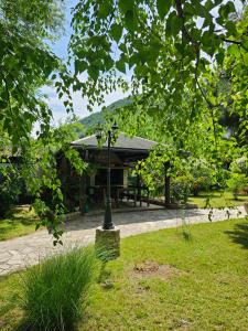 a lamp post in the grass in front of a building at Holiday House Bella in Bihać +15 photos