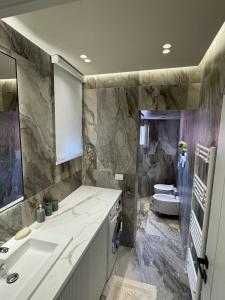 a bathroom with a sink and a toilet at Casa Topia in Durrës
