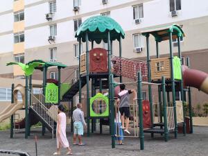 a group of people playing on a playground at MaryneL Suites in Suba
