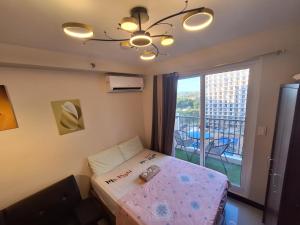 MaryneL Suites في Suba: غرفة صغيرة بها سرير ونافذة